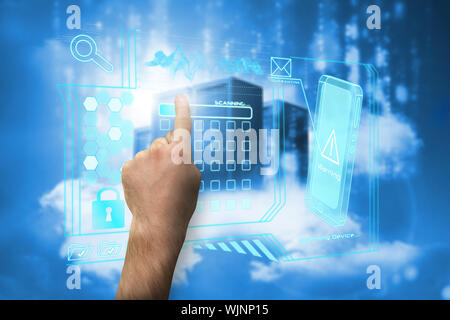 Hand pointing against cityscape on cloud Stock Photo