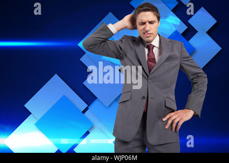 Thinking businessman scratching head against blue cube pattern Stock Photo