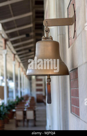Yellow bell at the railway station. Old history. Taken from the side
