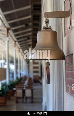 Yellow bell at the railway station. Old history. Taken from the side