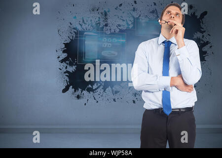 Thinking businessman biting glasses against splash showing technology interface Stock Photo