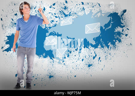 Handsome guy pointing against splash on wall revealing email graphic Stock Photo