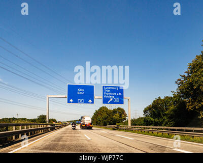 Germany - Aug 22, 2019: Koln, Bonn, Luxembourg, Trier, Frankfurt am Main and Koblenz city names on the highway signs in Germany Stock Photo