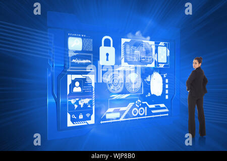Serious businesswoman against shiny cogs on blue background Stock Photo