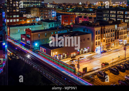 Rooftop view of the city at night. Looking down on the streets of Chicago in Fulton Market West Loop. Stock Photo