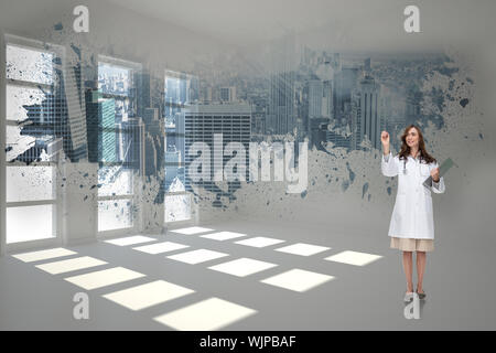 Smiling doctor pointing against splash showing cityscape Stock Photo