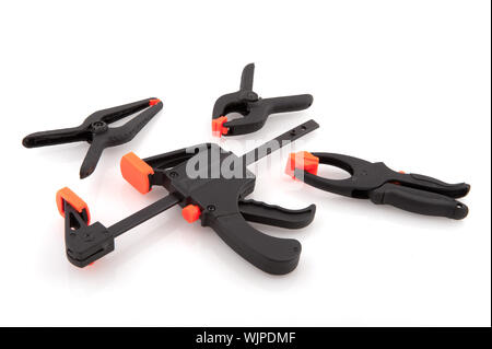 glue clamps in black and orange on white background Stock Photo