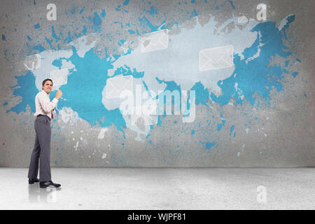 Thinking businessman holding pen against splash on wall revealing international email concept Stock Photo