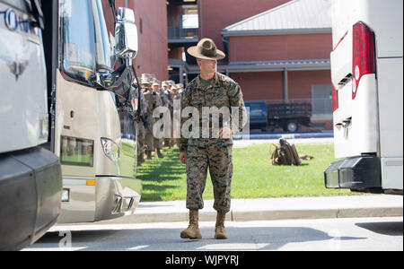 Beaufort, South Carolina, USA. 03 September, 2019. A U.S. Marine Drill Instructor checks buses lined up to take recruits to an evacuation site at the Marine Corps Recruit Depot Parris Island September 3, 2019 in Beaufort, South Carolina. The low lying region is under a mandatory evacuation order as Hurricane Dorian begins making way up the East Coast to South Carolina. Credit: Dana Beesley/USMC/Alamy Live News Stock Photo