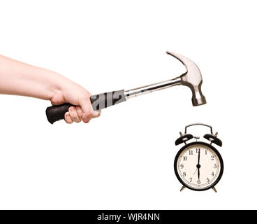 Alarm Clock and hammer in hand isolated on white background Stock Photo