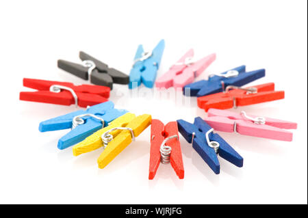 colorful clothes pins in circle pattern isolated over white Stock Photo