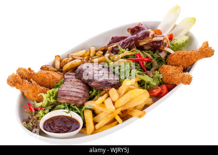Platter of mixed meats, salad and French fries Stock Photo