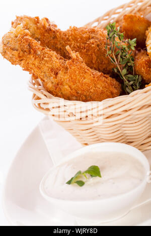 Crisp crunchy golden chicken legs and wings Stock Photo