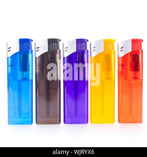 Row of vividly coloured plastic disposable lighters for smokers in red, yellow, two shades of blue and black isolated on a white background Stock Photo