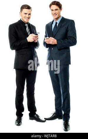 Smiling businesspeople sharing their mobile numbers Stock Photo