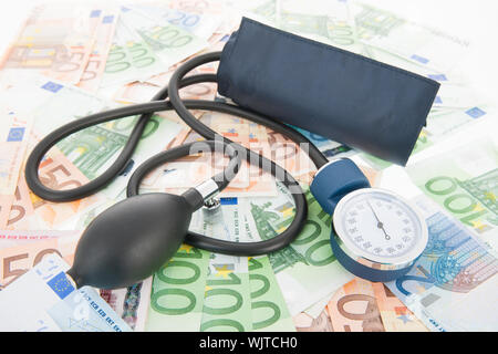 Costs of healthcare with banknotes and Blood pressure meter Stock Photo