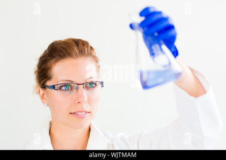 Portrait of a female researcher carrying out research in a chemistry lab (color toned image; shallow DOF) Stock Photo