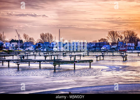 Sunset behind floating homes at Bluffers park marina in Toronto, Canada.  Winter. Stock Photo