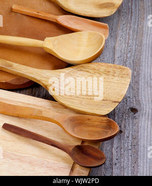 Arrangement of Wooden Spoons and Cutting Boards isolated on Rustic Wooden background Stock Photo