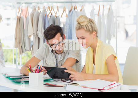 Two fashion designers using digital laptop in a studio Stock Photo