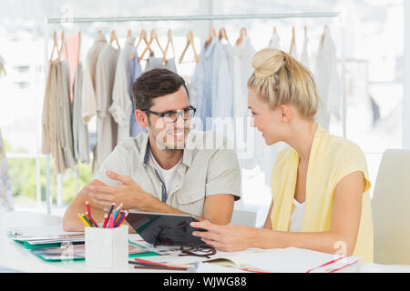 Two fashion designers using digital laptop in a studio Stock Photo