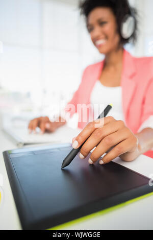 Casual female photo editor using graphics tablet in a bright office Stock Photo