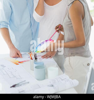 Interior designer showing colour wheel to client in her studio Stock Photo