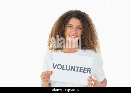 Happy volunteer showing a poster on white background Stock Photo
