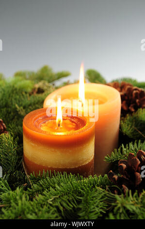 Arrangement of burning Christmas candles and green spruce branches Stock Photo