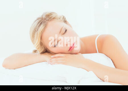 Peaceful young blonde sleeping on her bed at home in the bedroom Stock Photo