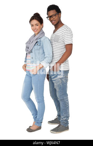 Full length portrait of a smiling cool young couple over white background Stock Photo