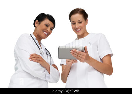 Two female doctors using digital tablet over white background Stock Photo