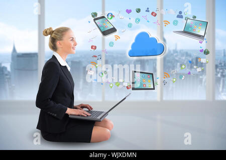 Digital composite of blonde businesswoman sitting using laptop with cloud and app icons Stock Photo