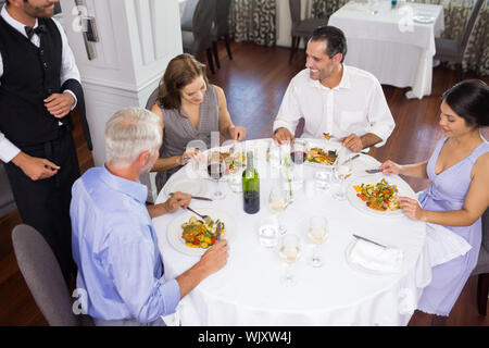 Business colleagues sitting around dining table in the restaurant Stock Photo