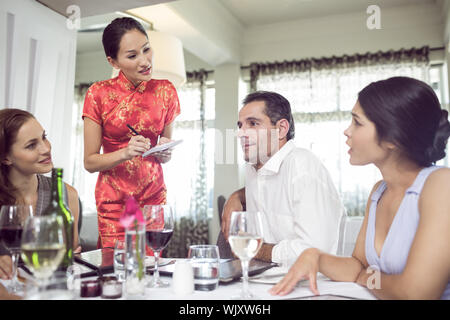 Business colleagues sitting around dining table in the restaurant Stock Photo