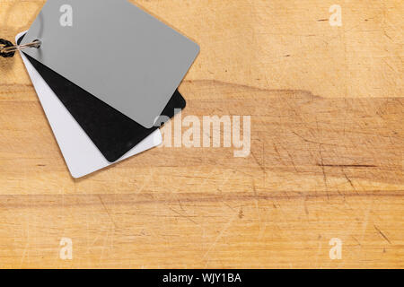 Photography gray card for white balance isolated on a cutting board background. Stock Photo