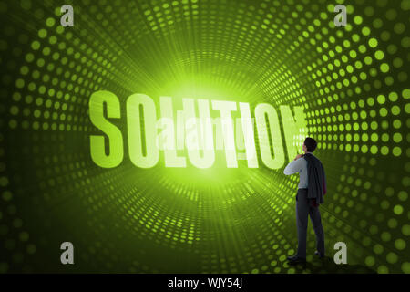 The word solution and businessman holding his jacket against green pixel spiral Stock Photo