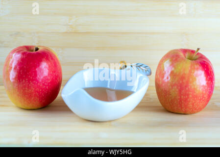 Honey and apples on wooden table background. Stock Photo