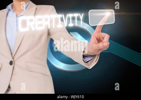 Businesswomans finger touching creativity button against shiny arrow pointing to the right Stock Photo