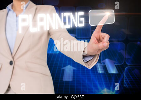 Businesswomans finger touching planning button against blue squares and arrows on black background Stock Photo