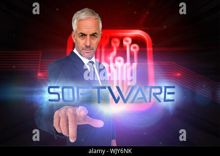 The word software and businessman pointing against shiny red circuit board on black background Stock Photo