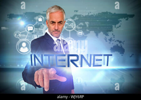 The word internet and businessman pointing against futuristic technology interface Stock Photo