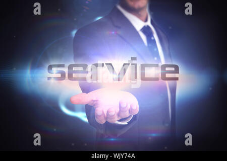The word service and businessman presenting against black background with shiny sphere Stock Photo