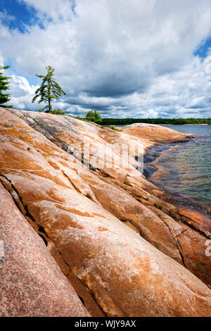Smooth rocky lake shore of Georgian Bay in Killbear provincial park near Parry Sound, Ontario, Canada. Stock Photo