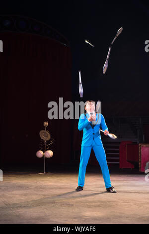 Baraboo, WI - 25 August 2019: A juggler performs tricks in front of a crowd in a circus Stock Photo