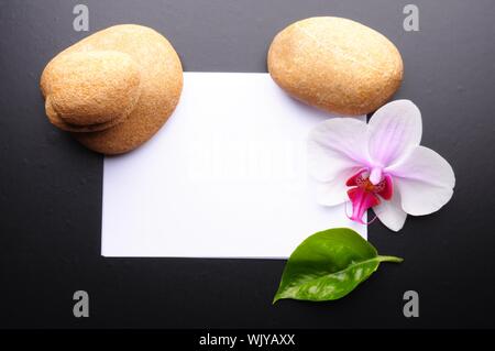zen or spa stones with blank and empty copyspace paper Stock Photo