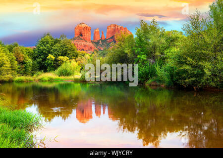 The view of Cathedral Rock in Sedona, Arizona. The towering rock formations stand out like beacons in the dimmed landscape of the Red Rock State Park. Stock Photo