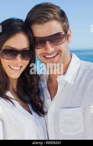 Happy couple wearing sunglasses and smiling at camera Stock Photo