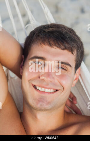 Attractive man lying in hammock Stock Photo