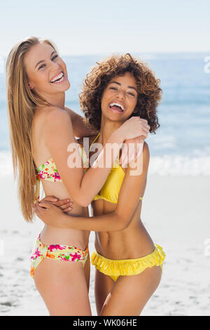 Two smiling friends hugging each other Stock Photo